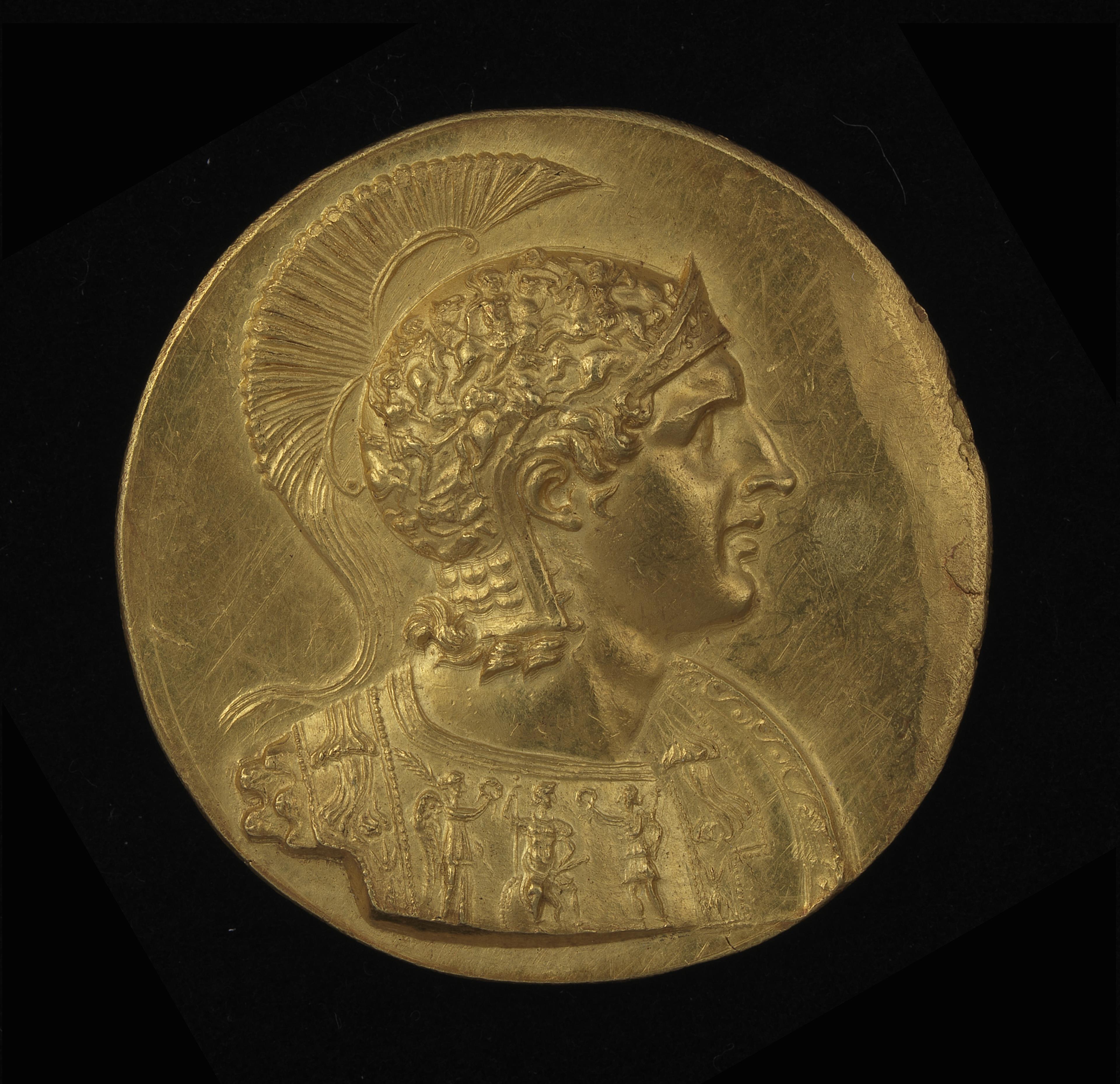 Busto couraçado de Alexandre com escudo e elmo ático em vista de frente para a direita (anv.); Atena  de pé (rev.)